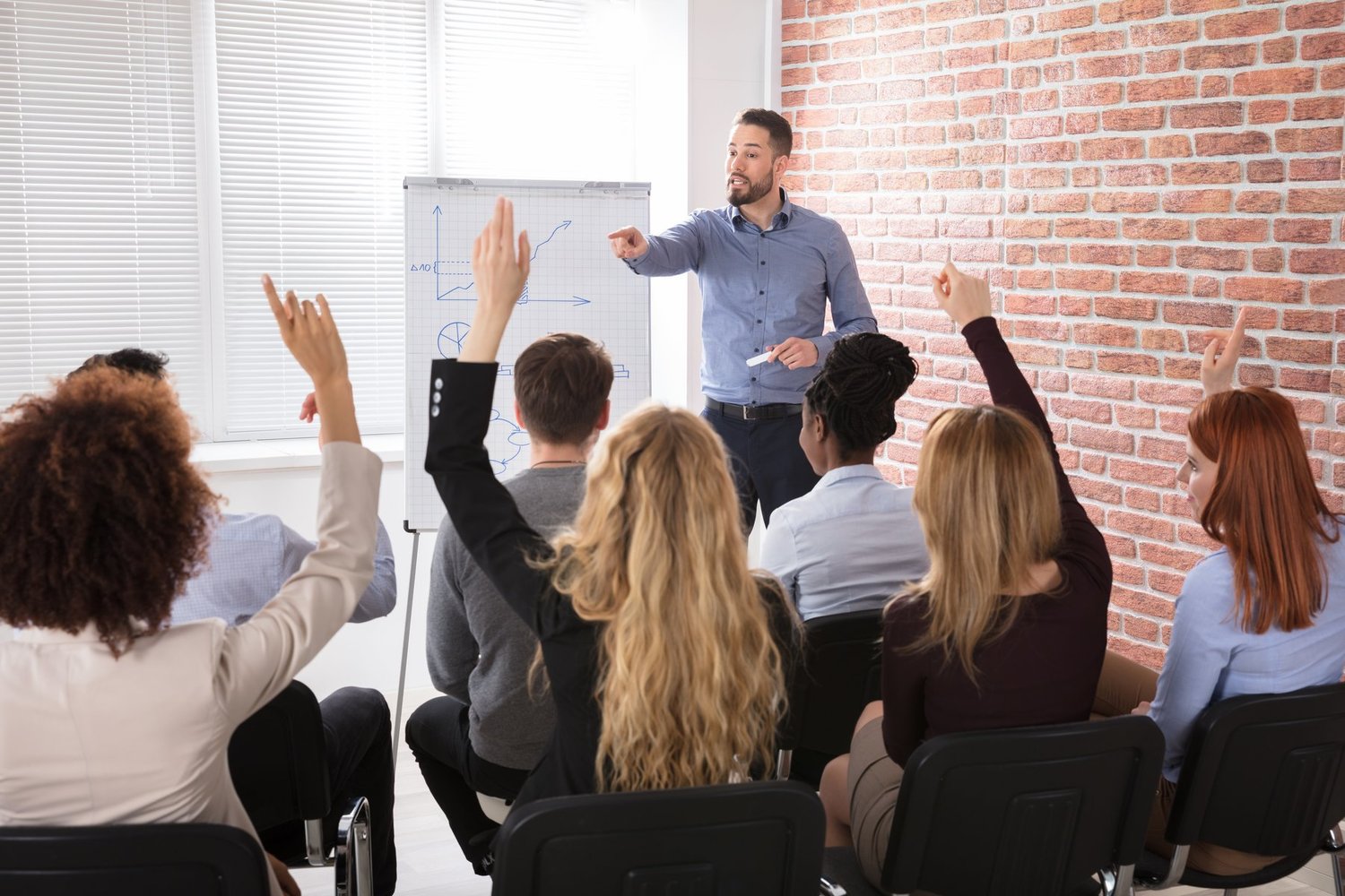 Teacher in front of classroom with students