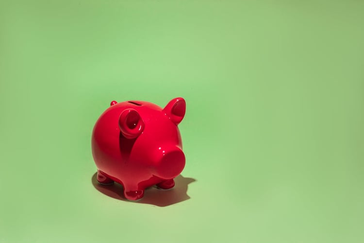 A red piggy bank on a green background